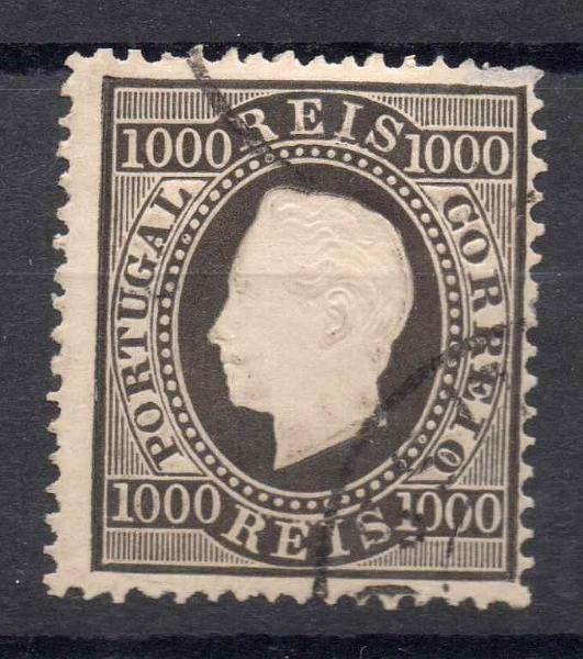 2103.jpg -     Lote:    2103      Lotes pelo Correio      Portugal        Descrição:         1884 &mdash; D. Luís I. Fita direita. Novo valor. CE67, 1000 reis preto, denteado 13 &frac12;, com ligeiro defeito no denteado. Valor de catálogo &euro; 142,00.        O       Valor Base:     &euro; 10,00     Valor Venda:     Retirado     