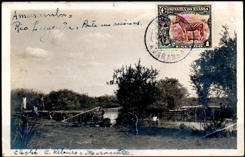 0102.jpg -     Lote:    102      Colecção IMPÉRIO      Companhia do Niassa       Descrição:         192&frac12;3 &mdash; Motivos diversos. Postal ilustrado fotográfico (Amaramba &mdash; Rio Lugenda &mdash; Ponte em ruínas * cliché C. Ribeiro - Maracotera) circulado de Amaramba (28.04.27) para a Bélgica, com selo de 1E preto e castanho vermelho, CE123. Carimbo circular de AMARAMBA batido a preto.        PI       Valor Base:     &euro; 50,00     Valor Venda:     &euro; 260,00     